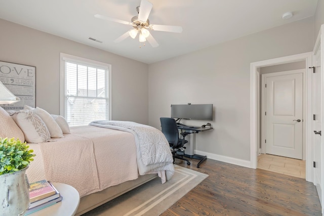 bedroom featuring dark hardwood / wood-style floors and ceiling fan