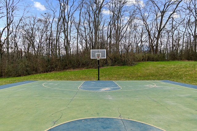 view of sport court with a lawn