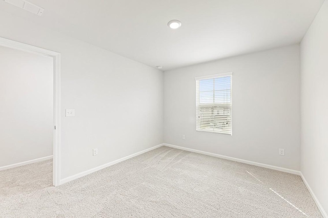 empty room featuring light carpet