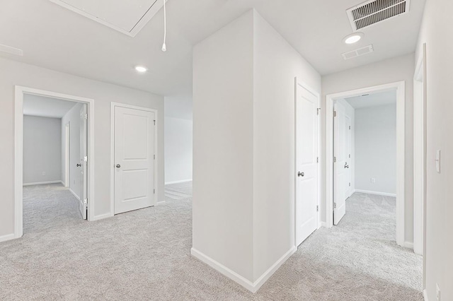 hallway with light colored carpet