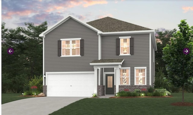 view of front of home with a garage and a lawn