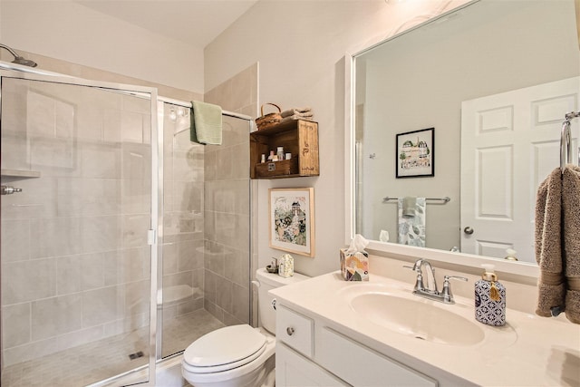 bathroom with vanity, a shower with shower door, and toilet