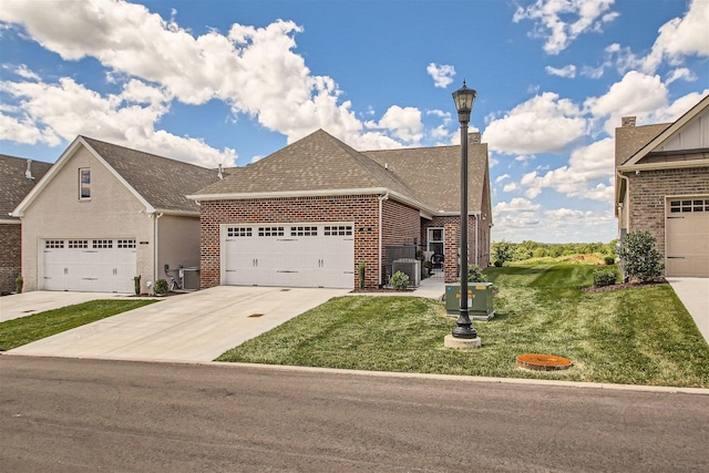 view of front facade featuring a garage, cooling unit, and a front lawn