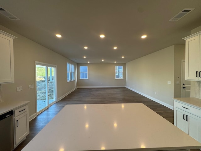 kitchen featuring white cabinetry, dishwasher, and dark wood-type flooring