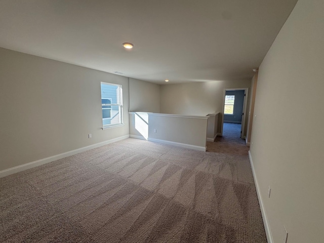 unfurnished room featuring light colored carpet