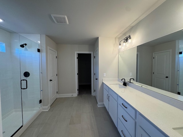 bathroom featuring vanity and an enclosed shower