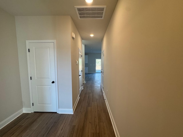 corridor with dark hardwood / wood-style flooring