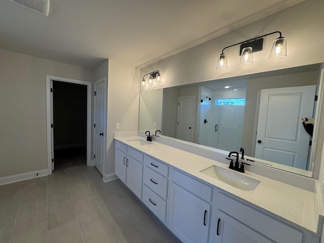 bathroom featuring vanity, tile patterned floors, and walk in shower