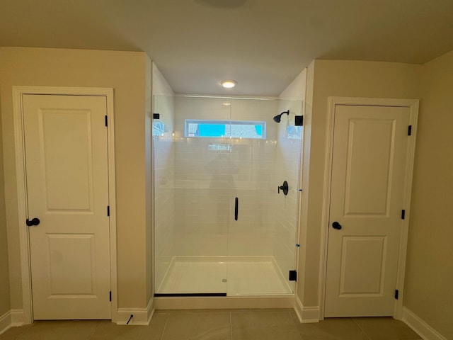 bathroom with tile patterned floors and an enclosed shower