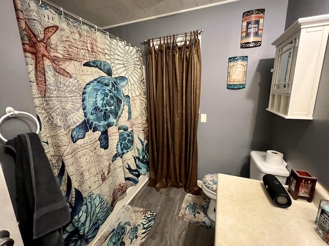 bathroom featuring hardwood / wood-style flooring and toilet