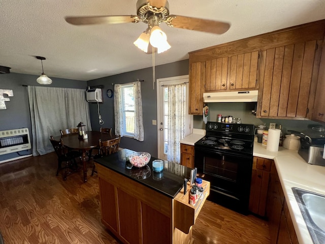 kitchen with black electric range oven, sink, heating unit, a textured ceiling, and dark hardwood / wood-style flooring