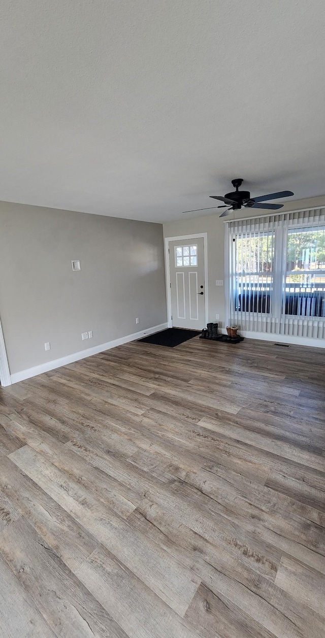 interior space featuring plenty of natural light, ceiling fan, and light hardwood / wood-style flooring