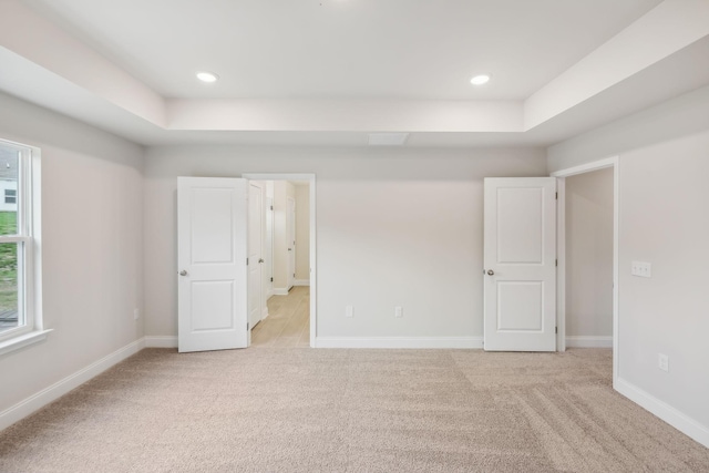 unfurnished bedroom with recessed lighting, light colored carpet, and baseboards