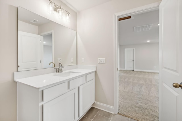 bathroom with vanity, visible vents, and baseboards