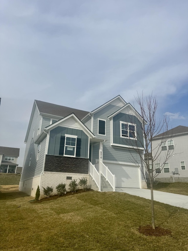 view of front of property featuring a garage, concrete driveway, crawl space, a front lawn, and board and batten siding