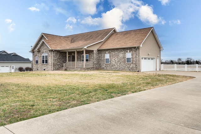 view of front of home with a garage, a front yard, and a porch