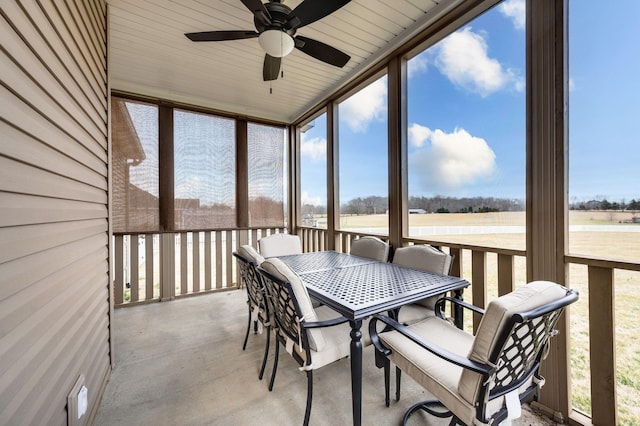 sunroom featuring ceiling fan