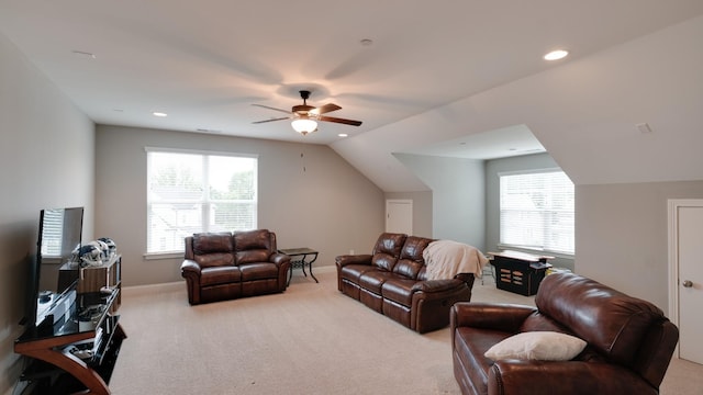 living room with vaulted ceiling, light colored carpet, and ceiling fan