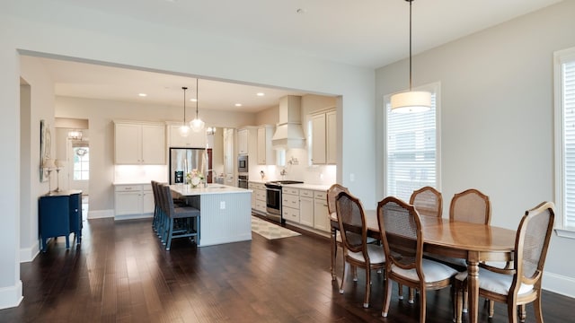 dining area with sink and dark wood-type flooring