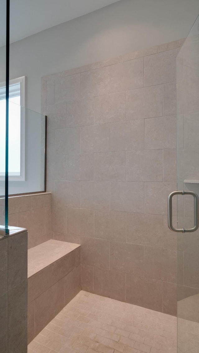 bathroom with a shower with shower door