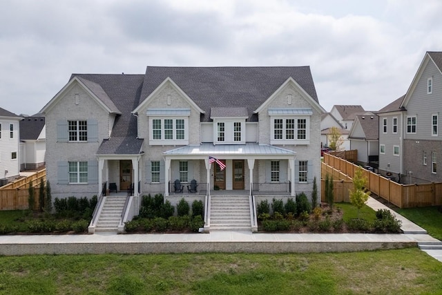 view of front of property featuring a porch and a front lawn