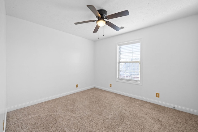 spare room with ceiling fan, carpet floors, and a textured ceiling