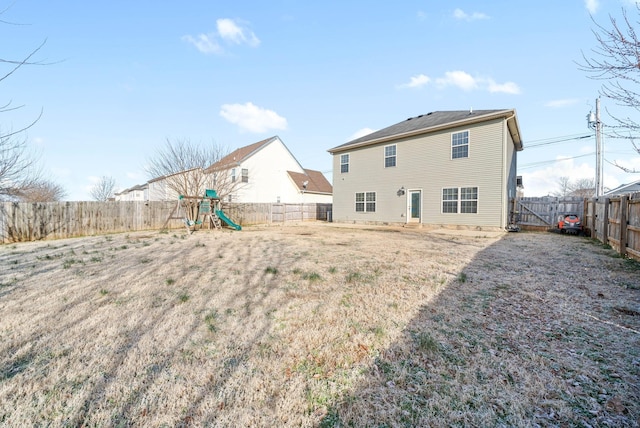 back of property featuring a playground