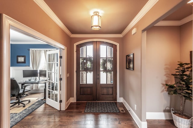 foyer featuring dark hardwood / wood-style floors, ornamental molding, and french doors