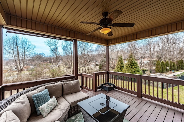 wooden terrace with an outdoor hangout area and ceiling fan