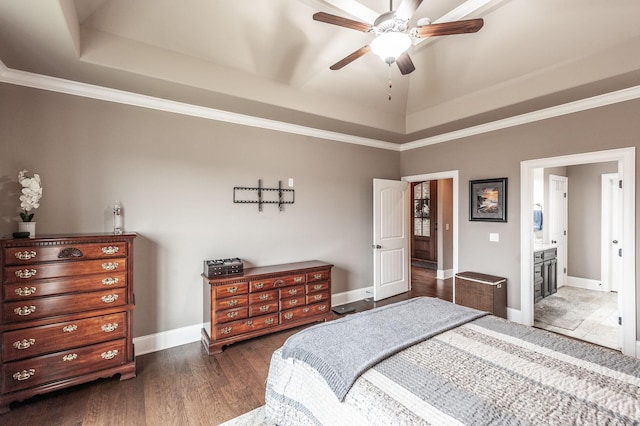 bedroom with ensuite bath, ornamental molding, dark hardwood / wood-style floors, a raised ceiling, and ceiling fan