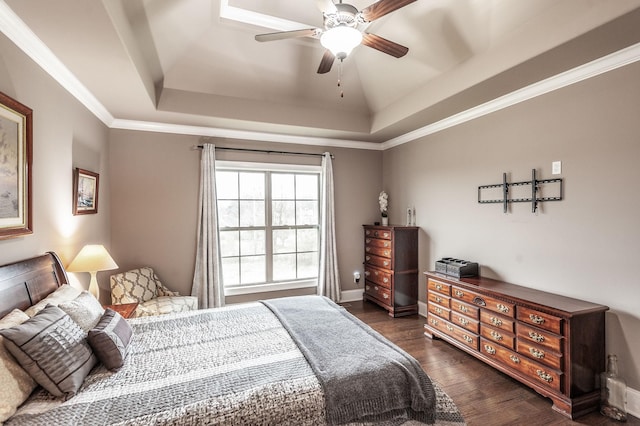 bedroom featuring a raised ceiling, ornamental molding, dark hardwood / wood-style floors, and ceiling fan