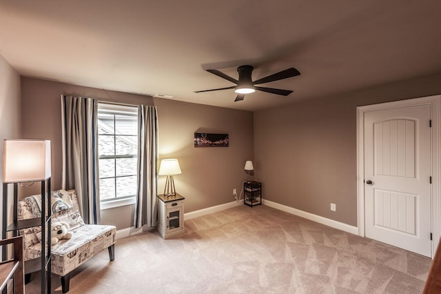 unfurnished room featuring light carpet and ceiling fan