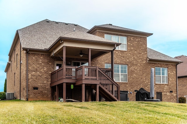 back of property with a wooden deck, a yard, central AC unit, and ceiling fan