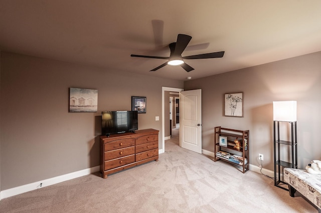 living area with ceiling fan and light colored carpet