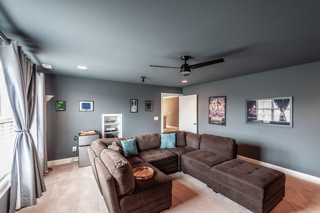 living room with light colored carpet and ceiling fan