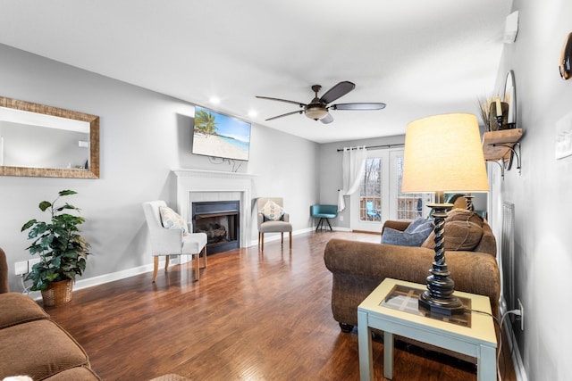 living room featuring dark hardwood / wood-style flooring and ceiling fan