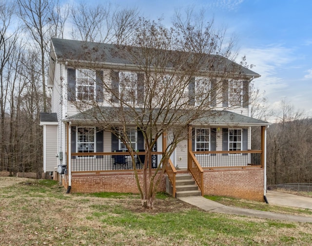 view of front of property with covered porch and a front lawn