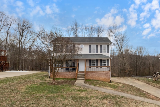 view of front of home with a front yard and covered porch