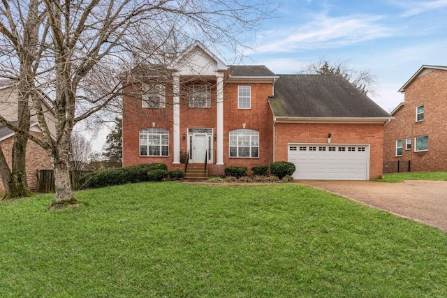 view of front of property featuring a garage and a front lawn