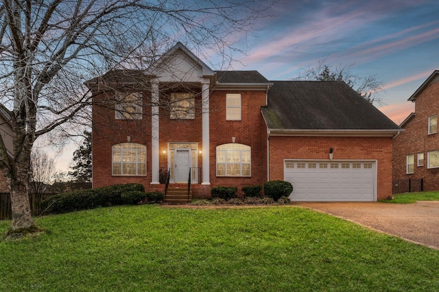 view of front facade with a garage and a lawn