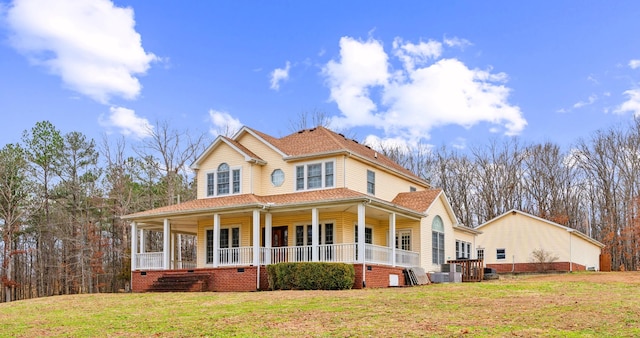 view of front facade featuring central AC, a porch, and a front lawn