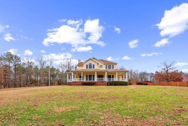 farmhouse inspired home with a porch and a front lawn