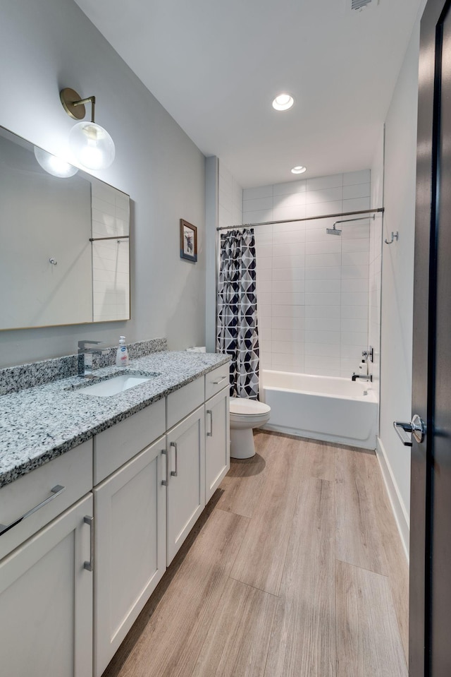 full bathroom with vanity, hardwood / wood-style floors, shower / bath combination with curtain, and toilet