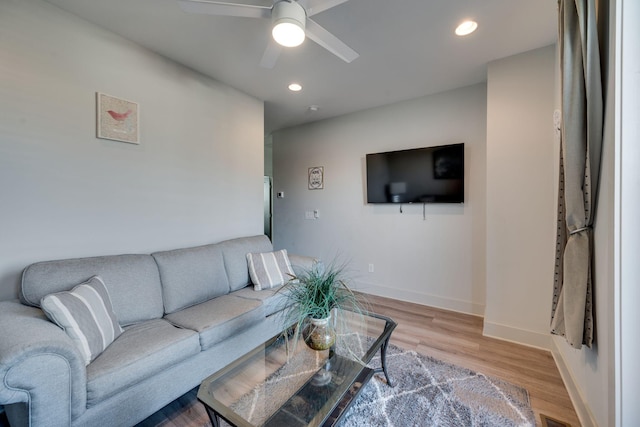 living room with hardwood / wood-style floors and ceiling fan