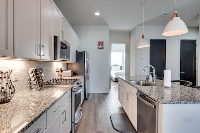 kitchen with appliances with stainless steel finishes, sink, and white cabinets