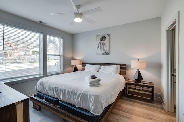 bedroom with ceiling fan and light wood-type flooring