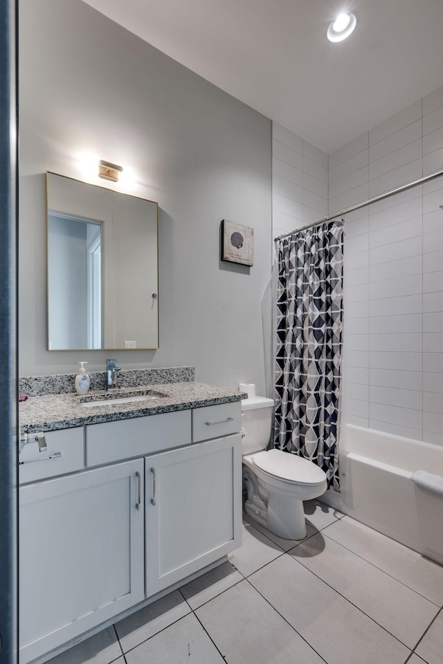 full bathroom with vanity, shower / bathtub combination with curtain, tile patterned floors, and toilet