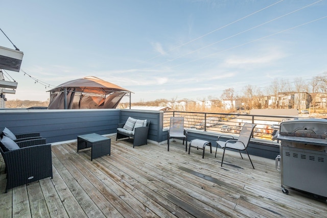 wooden terrace with a grill