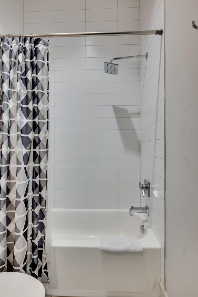 bathroom with shower / tub combo with curtain and toilet