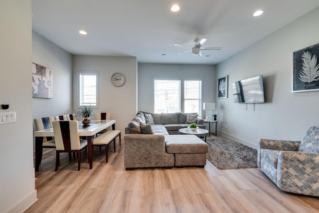 living room featuring ceiling fan and light hardwood / wood-style floors